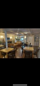 a living room with tables and chairs and a dining room at The Countryman Inn in Llantrisant