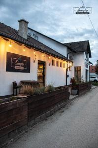 a restaurant with lights on the side of a building at Sempre Étterem És Panzió in Székesfehérvár