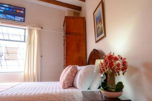 Voodi või voodid majutusasutuse Rincón Familiar Hostel Boutique toas