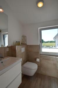 KronsgaardにあるÆrøのバスルーム(トイレ、洗面台付)、窓が備わります。