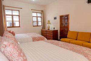 Voodi või voodid majutusasutuse Rincón Familiar Hostel Boutique toas