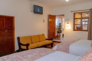 TV a/nebo společenská místnost v ubytování Rincón Familiar Hostel Boutique