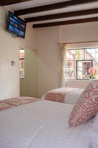 Voodi või voodid majutusasutuse Rincón Familiar Hostel Boutique toas