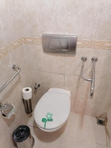 a bathroom with a toilet with a sticker on the lid at Oran Hotel in Istanbul
