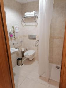 a bathroom with a toilet and a sink at Oran Hotel in Istanbul