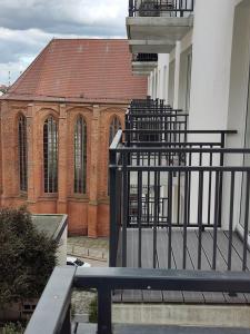 a bench in front of a building with a church at Apartament 400 bulwary Stare Miasto Apartamenty No 1 in Szczecin