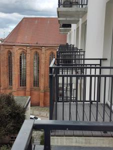 a bench in front of a building with a church at Apartament 400 Apartamenty No 1 Stare Miasto in Szczecin