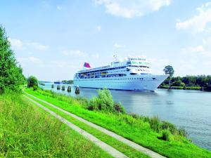 a cruise ship is docked in the water at Fewo 1 "Landhaus am Grashof" in Offenbüttel