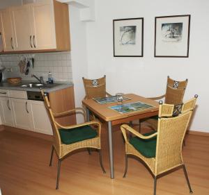 a kitchen with a table and chairs in a room at Likedeeler Weg 1 Whg 18 in Zingst