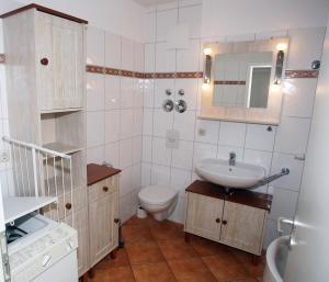 a small bathroom with a sink and a toilet at Likedeeler Weg 1 Whg 18 in Zingst