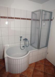 a bathroom with a shower and a bath tub at Likedeeler Weg 1 Whg 18 in Zingst