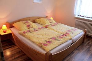 Haus Knoop - Whg 2 في Cismar: سرير مع اطار خشبي في الغرفة