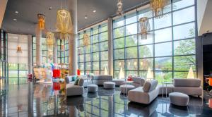 a lobby with couches and chairs and large windows at Spirit Hotel Gran Bilbao in Bilbao