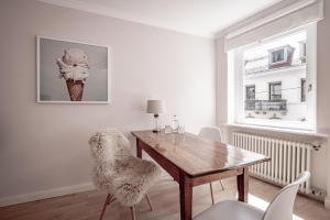 a dining room with a wooden table and chairs at Boutique Charme Apartments in Baden-Baden
