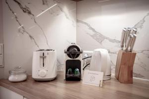 a counter with several appliances sitting on top of it at Boutique Charme Apartments Langestr 14 in Baden-Baden +16 photos