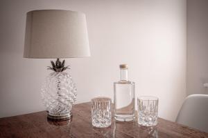 a bottle of wine and two glasses on a table at Boutique Charme Apartments Langestr 14 in Baden-Baden