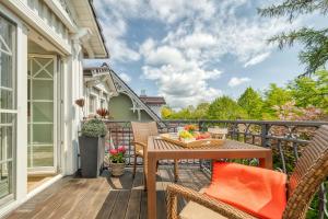 a balcony with a wooden table and chairs at Les Belles, Haus Cecile, FW Romantique, Whg 5 in Zingst