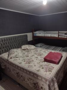 a bedroom with two beds in a room at Rancho Velho Tropeiro in São Francisco do Sul