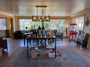 a living room with a table with wine bottles on it at Estes Mountain Inn in Estes Park