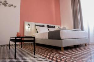 a bedroom with a bed and a couch and a table at Elegant apartment in the heart of Heraklion in Heraklio