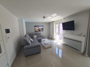 a living room with a couch and a tv at Villa Patricia in Stari Grad