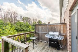 a patio with a grill and a table on a deck at GLOBALSTAY Modern Townhomes in Lakeshore Steps to the Beach in Hamilton