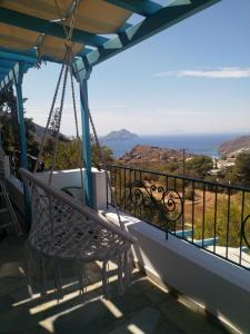a swing on a balcony with a view of the ocean at Villa Fenia in Aegiali