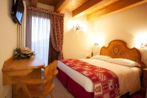 Postel nebo postele na pokoji v ubytování Garnì Astoria Hotel & SPA