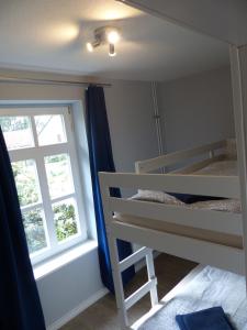 a bedroom with two bunk beds and a window at Ferienhaus Sonnenblick - a59190 in Walsrode
