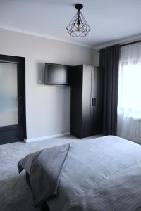 a bedroom with a large bed and a window at Apartament Royal in Dej