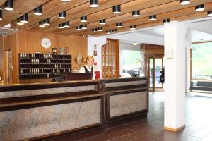 a woman standing at a counter in a restaurant at Stalheim Hotel in Stalheim