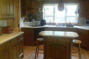 a kitchen with a counter and a sink and a window at Drumgowan House in Donegal