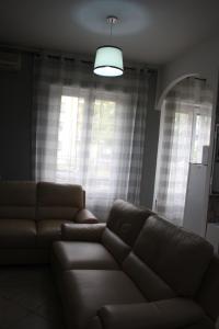 a living room with a couch and a window at My Home Milano ! in Milan