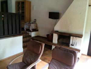 a living room with two chairs and a television at Ferienhaus Stausee Bitburg in Biersdorf