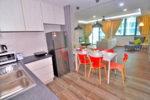 a kitchen and dining room with a table and red chairs at Vivacity Jazz Suite New Luxury Vivacity Cozy Home LV8 in Kuching