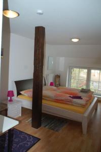 a bedroom with a large bed with a wooden post at FeWo Gotthard in Hanerau-Hademarschen