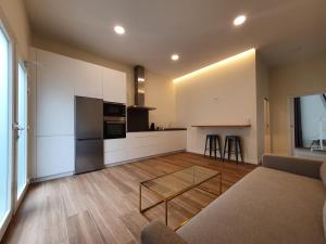 cocina y sala de estar con sofá y mesa en REDONDELA APARTMENTS - Bedroom, Bathroom & Kitchen, en Redondela