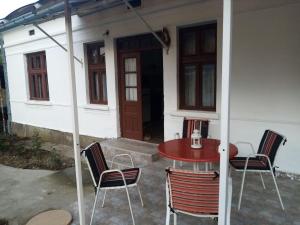 a patio with a table and chairs in front of a house at Apartmani Lina in Ribarska Banja