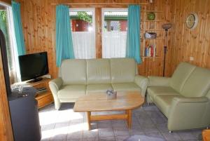 a living room with a couch and a coffee table at Ferienhaus Anke nur für Urlauber! in Bremke