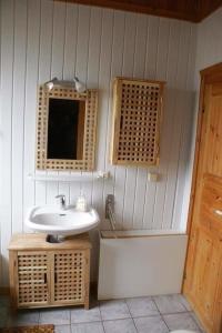 a bathroom with a sink and a bath tub at Ferienhaus Anke nur für Urlauber! in Bremke