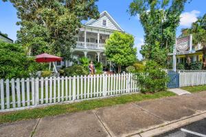 a white picket fence in front of a white house at Goodbread House Bed and Breakfast in Saint Marys