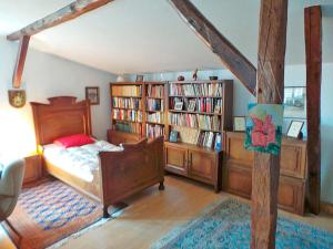 a bedroom with a bed and some book shelves at Drengenberg in Hanerau-Hademarschen