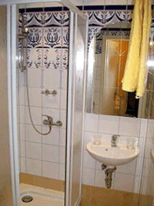 a bathroom with a shower and a sink at Mediterran Suite in Hoppegarten