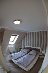 a large bed in a room with a window at Haus Swantje - Fewo 1 in Dahme
