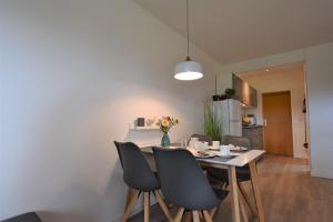 a dining room with a table and chairs at Landhaus Lippmann Whg1 in Grönwohldshorst