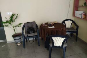 a room with a table and chairs and a plant at Studio in Agrinio