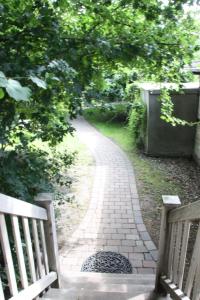 a walkway with two benches in a park at Muschelkorb in Hinrichsdorf