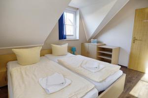 a bedroom with two beds with towels on them at Am Deich 32 in Zingst