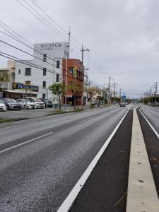 an empty street with buildings and cars on it at Aoi sanmyaku in Awase +7 photos