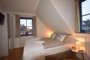 Ένα ή περισσότερα κρεβάτια σε δωμάτιο στο Ostseebrise FH 3